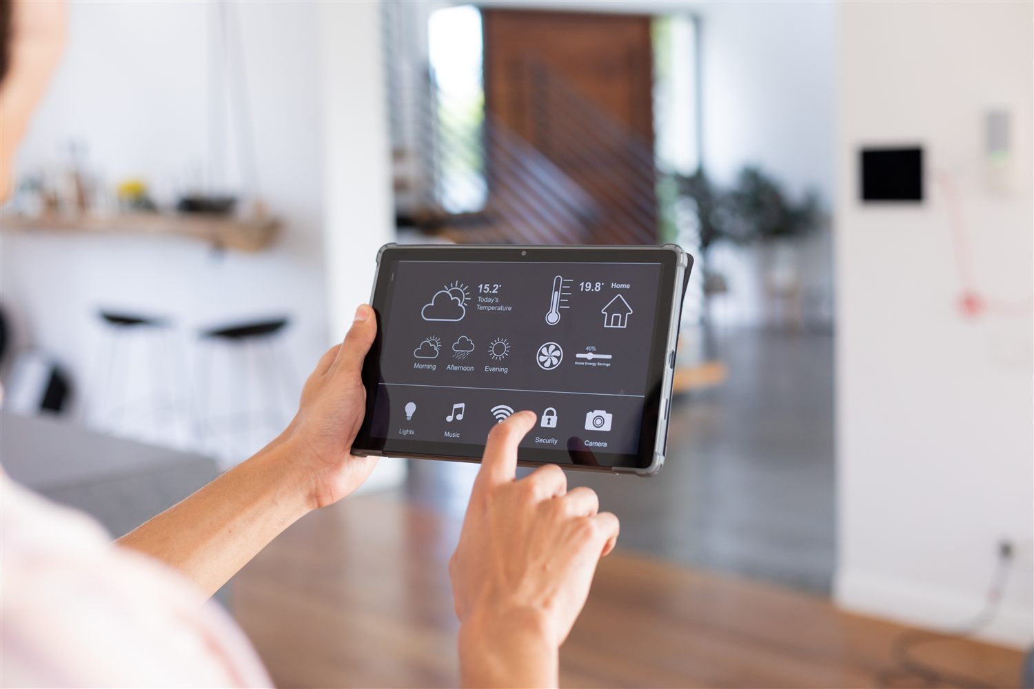 Person using a tablet to control a smart home interface